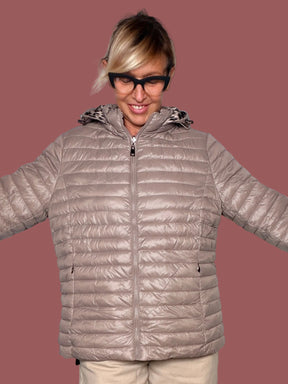 Piumino reversibile taupe con cappuccio e zip, indossato, vista frontale con braccia aperte