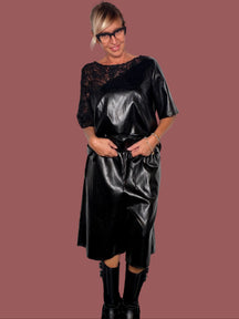 Bermuda ecopelle nero a gamba ampia con coulisse in vita, indossato con maglia coordinata, vista laterale