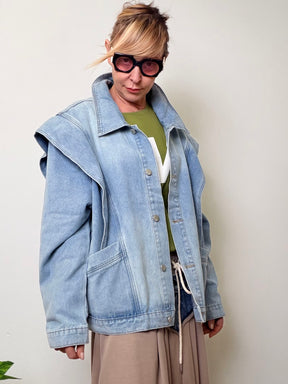 Giacca oversize in denim azzurro con spalline strutturate stile anni '80.