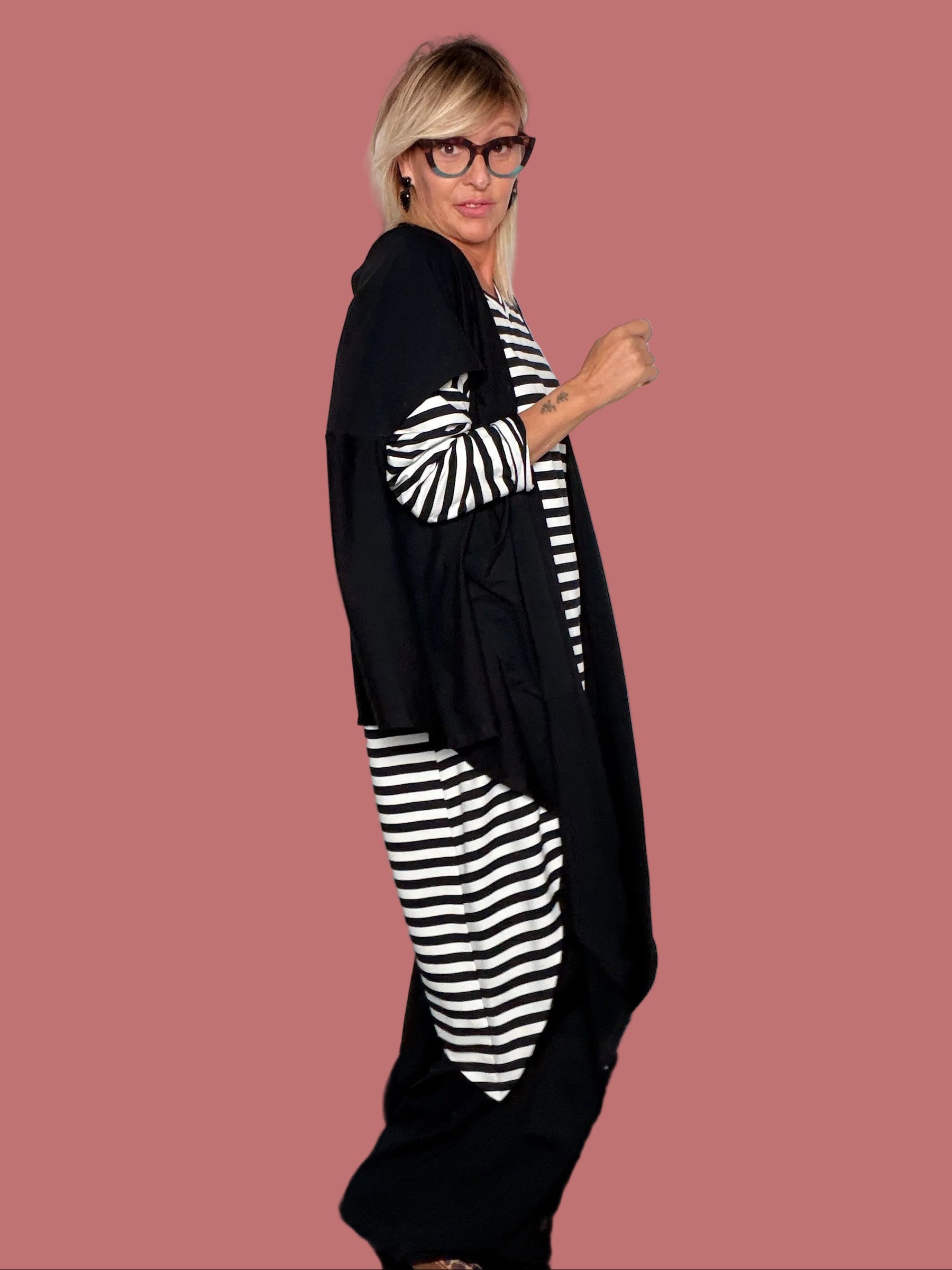 Gilet cardigan lungo nero asimmetrico abbinato a maglia a righe, vista laterale