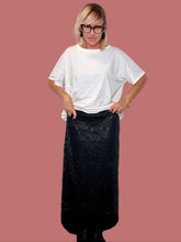 Gonna lunga Deja Vu in pizzo spalmato nero indossata con T-shirt bianca