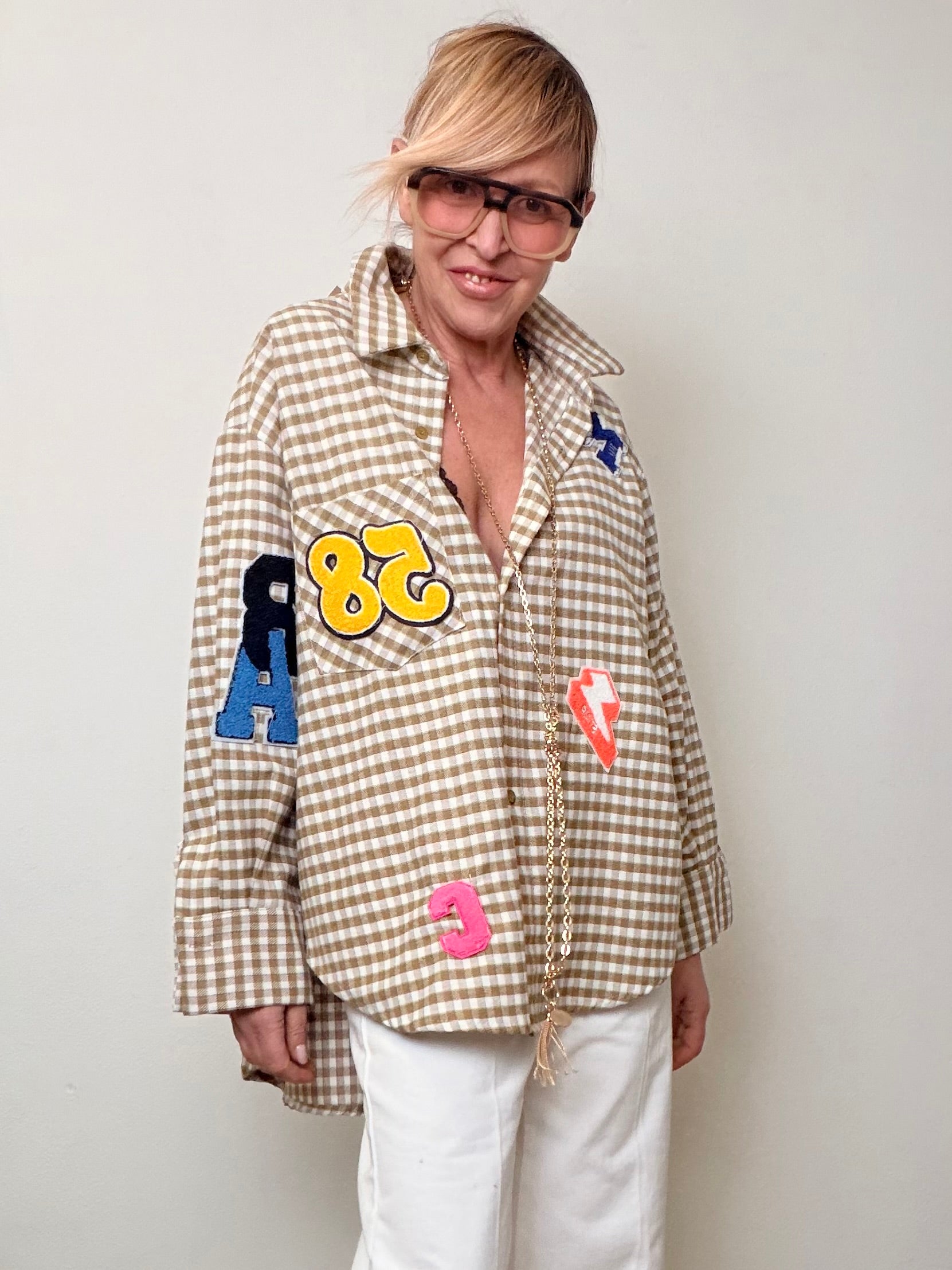 Camicia over a quadretti con patch decorative